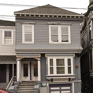 a gray house with white windows