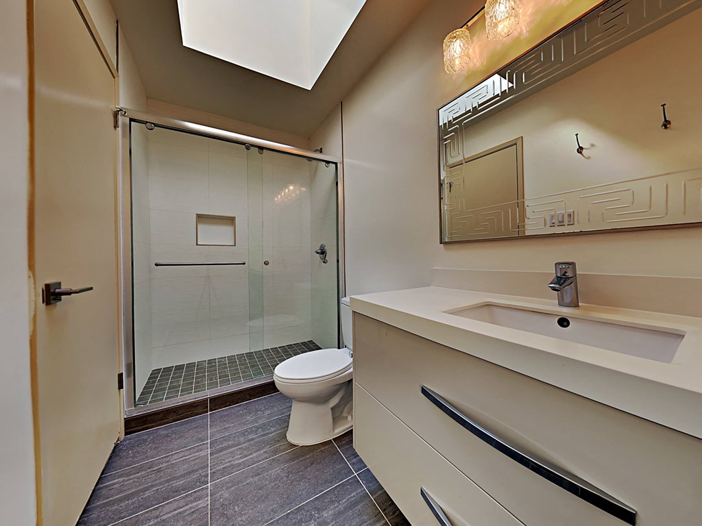 a bathroom with a toilet and a shower