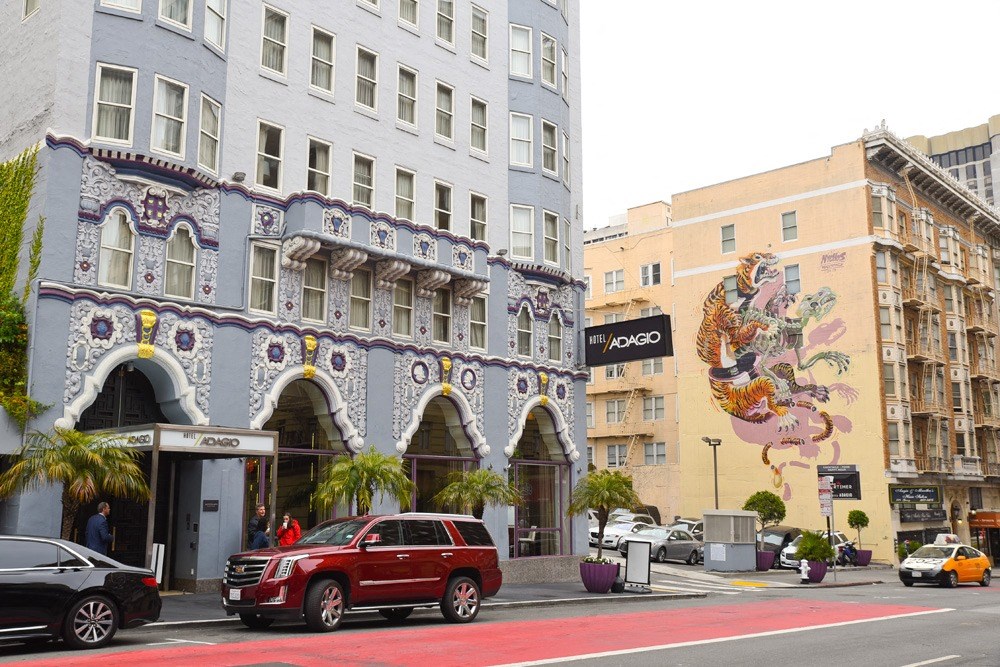 a mural on the side of a building on a city street