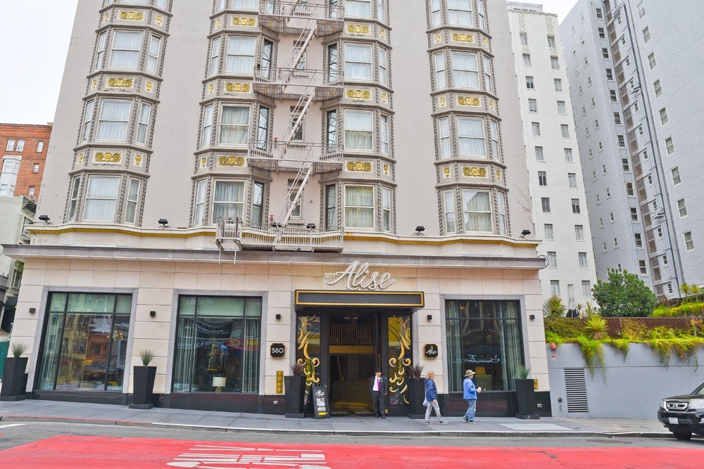people walking in front of a building on a city street