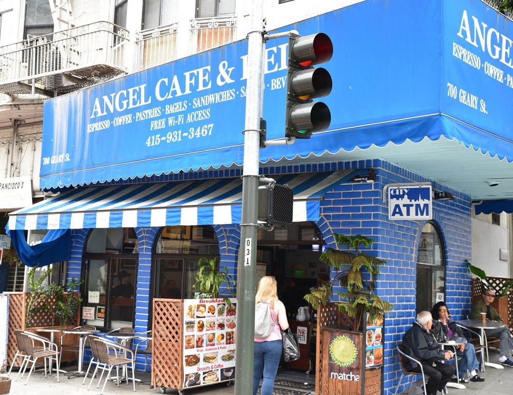 the facade of angel cafe and tea on the corner of a city street