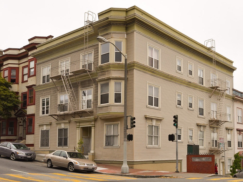 a tall building on the corner of a city street