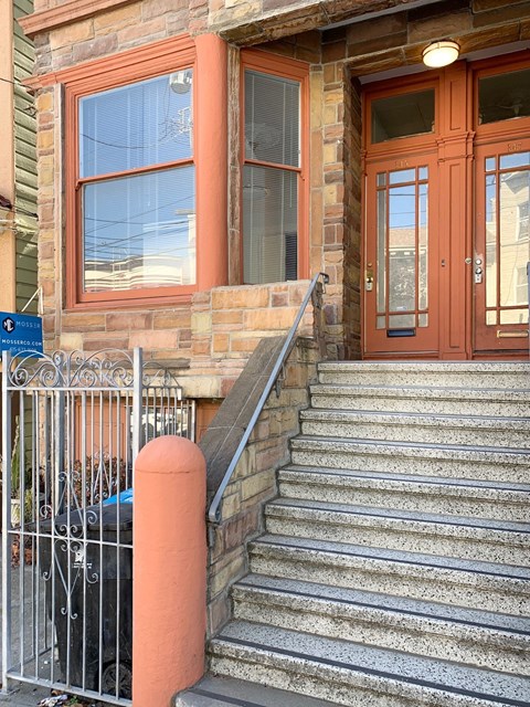 a set of stairs in front of a brick building