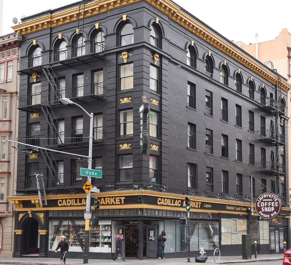 a black building on the corner of a city street