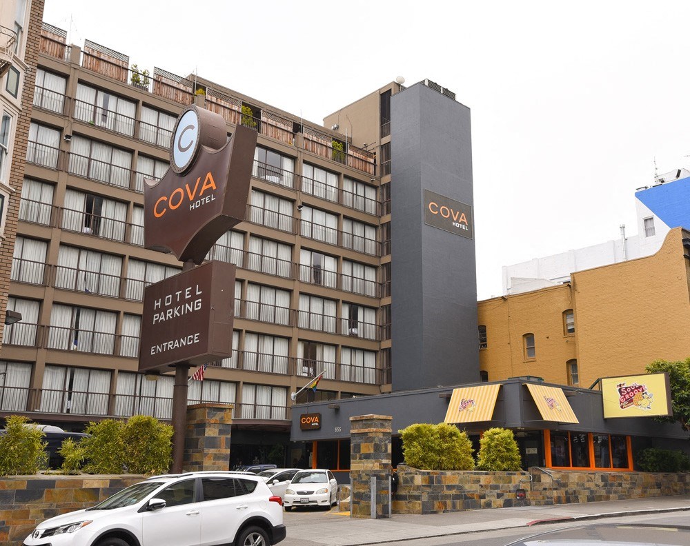 a hotel with cars parked in front of it