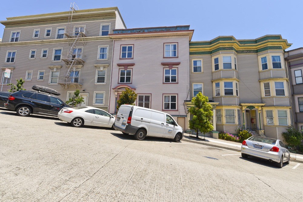 a parking lot with cars in front of a building