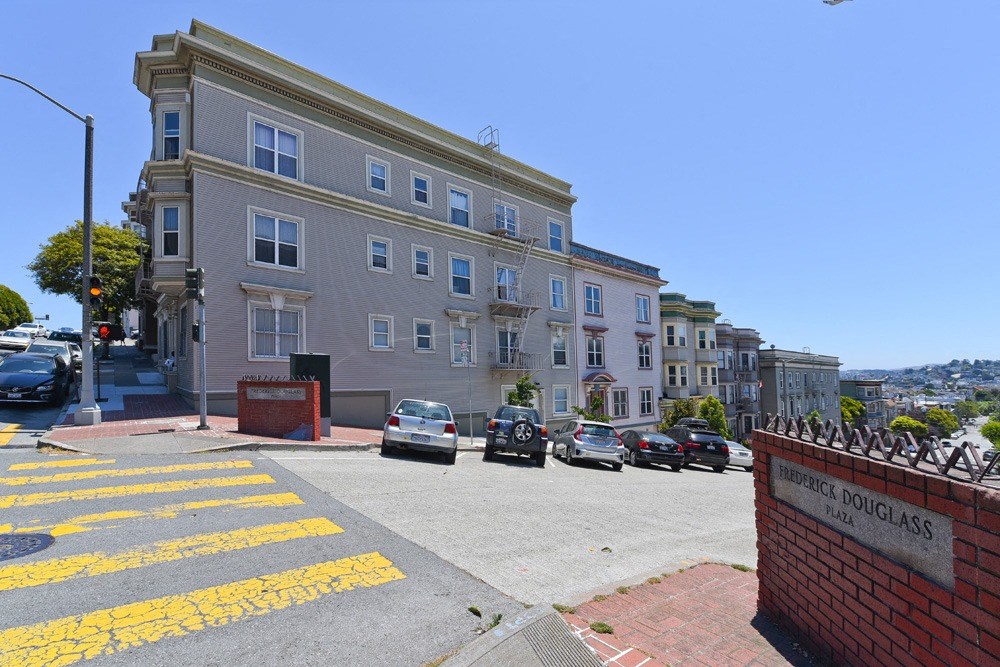 a city street with cars parked in front of a building