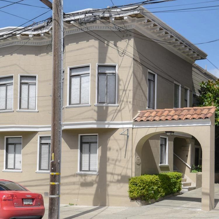 a building with a red car parked in front of it