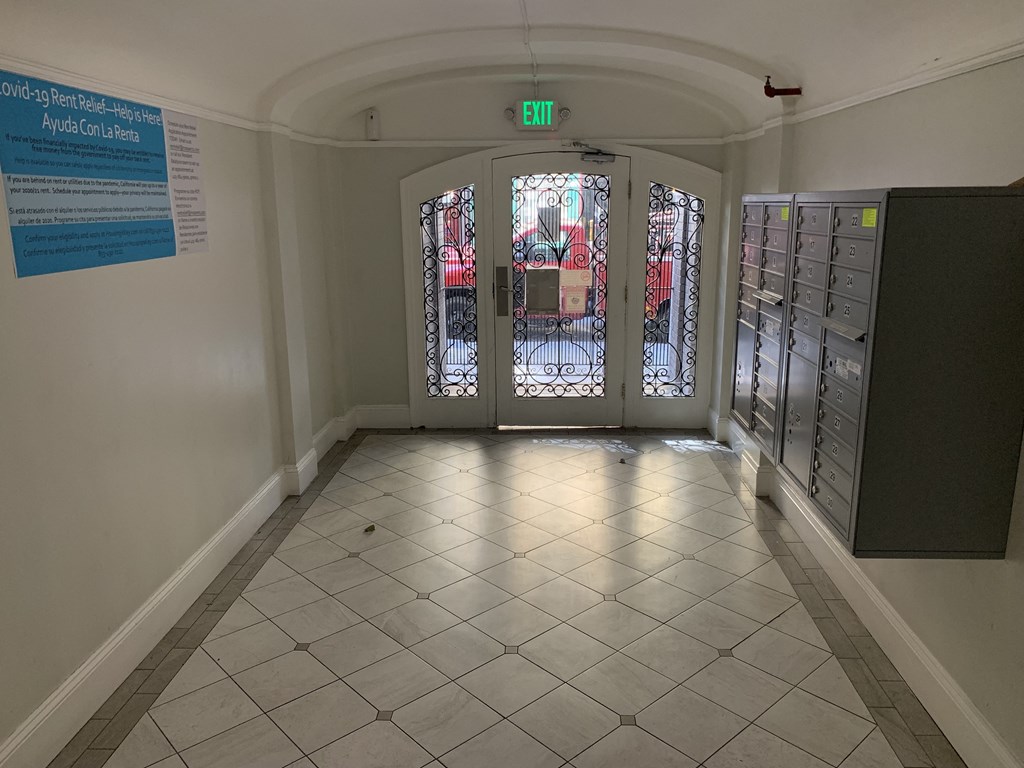 a view of the entrance to a building with doors and mailboxes
