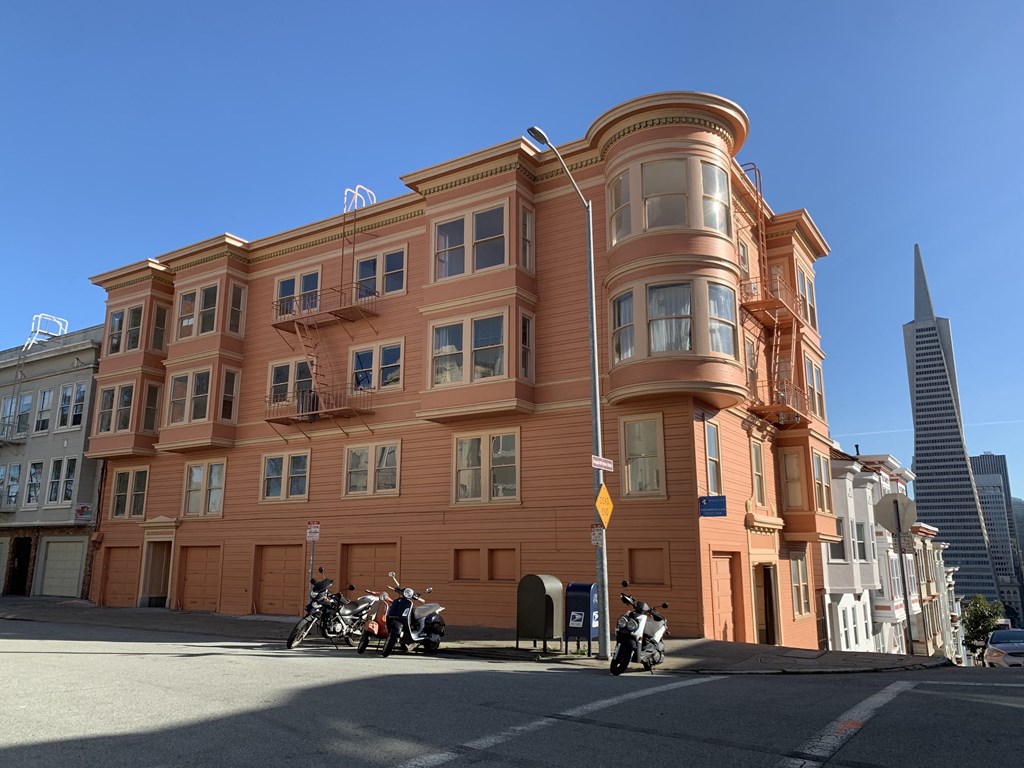 a building on a city street with motorcycles parked in front of it