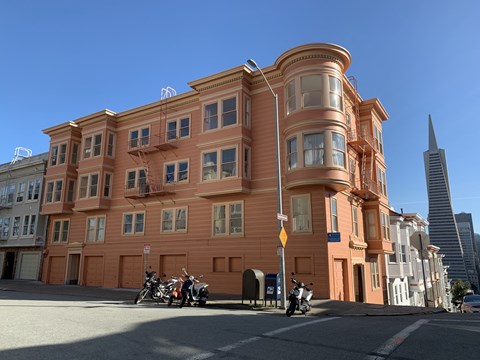 a building on a city street with motorcycles parked in front of it