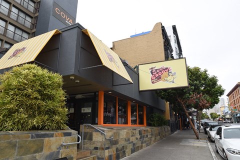 the front of a restaurant with a sign on the side