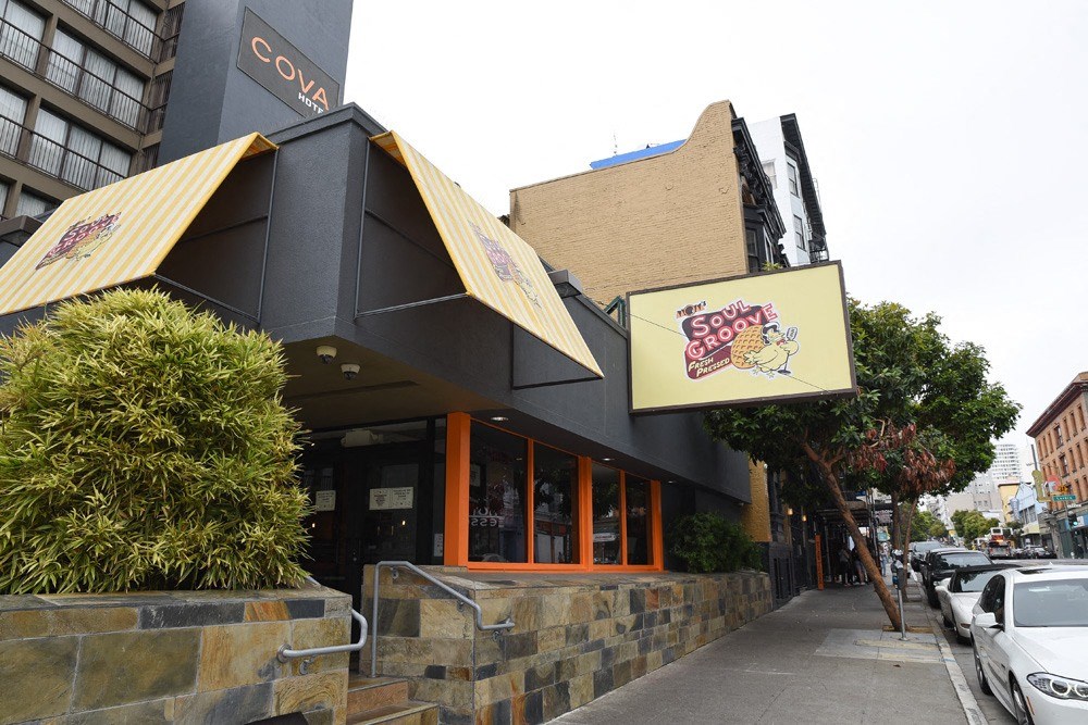 the front of a restaurant with cars parked outside of it