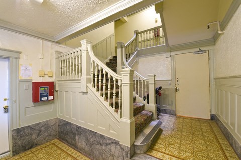 a stairwell in a house with a white staircase and a door