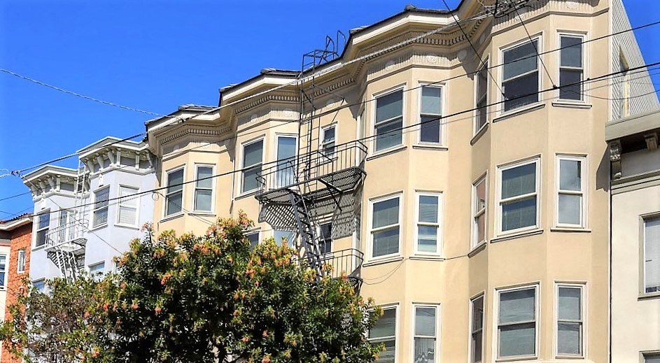 a tall building with a fire escape on the side of it