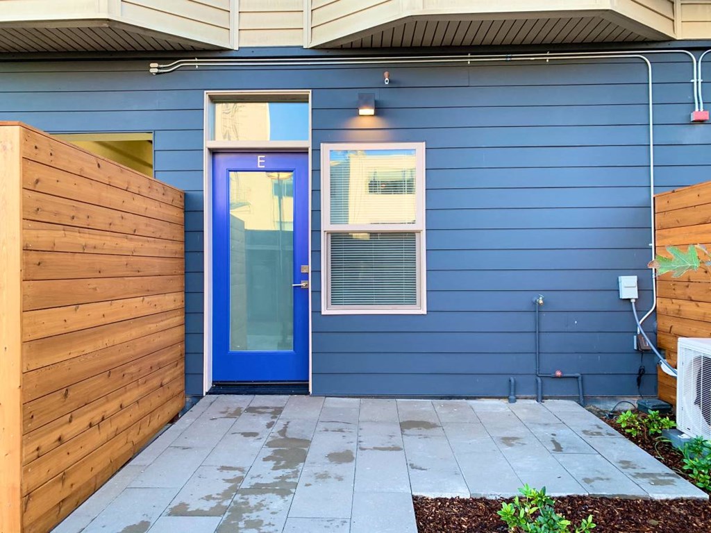 a blue house with a blue door and a wooden fence