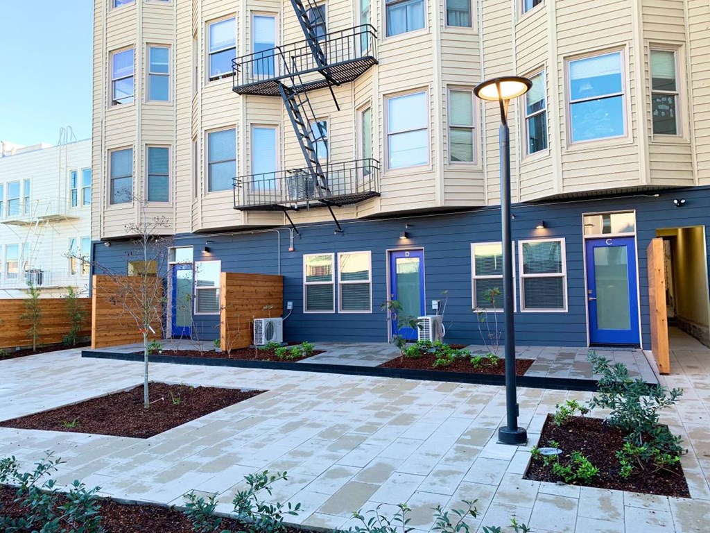 the front of a building with a patio and a street light