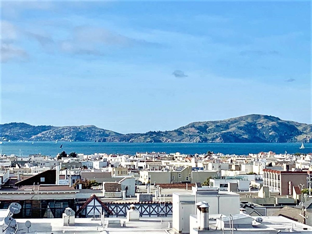 a view of the city and the water from a roof top