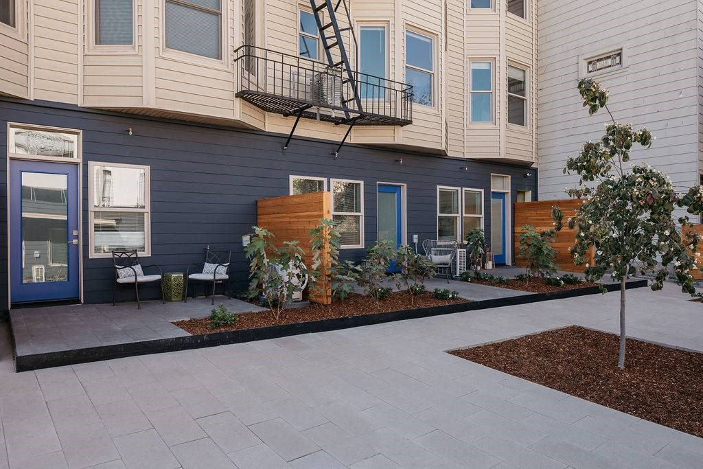a patio in front of a blue and white building