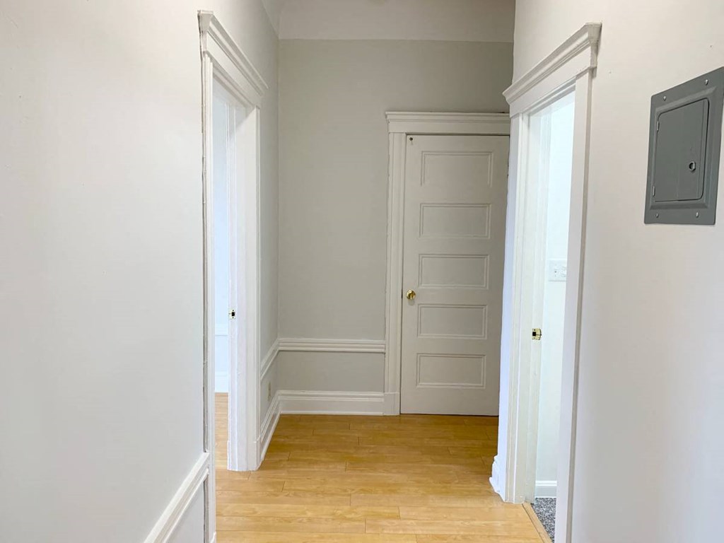 a hallway with two doors and a door to a closet