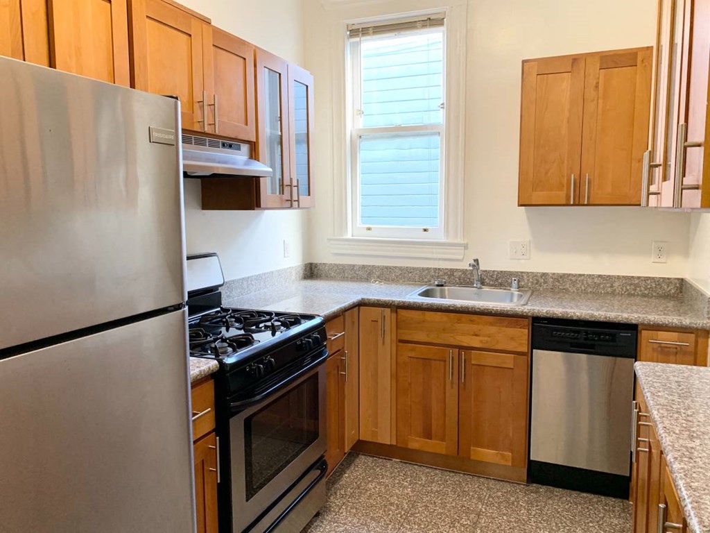 a kitchen with stainless steel appliances and wooden cabinets
