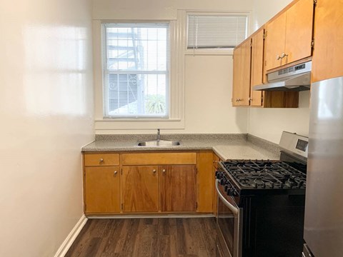 a small kitchen with a stove and a window