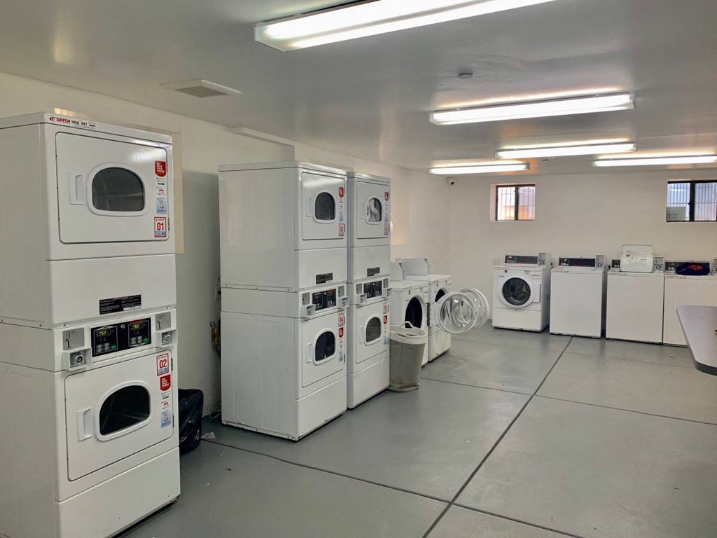 a group of washes and dryers in a room