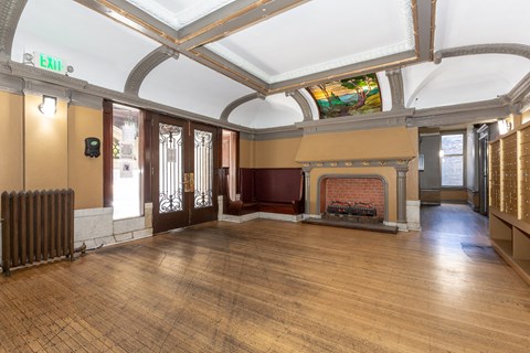 a large room with a fireplace and a stained glass ceiling