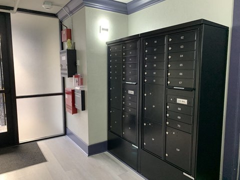 a set of lockers and a refrigerator in a room