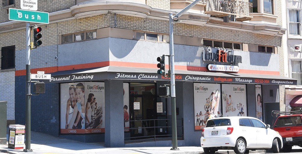 a car parked in front of a store on a city street