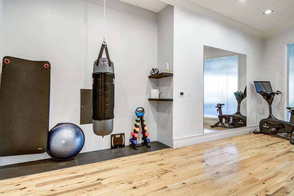 Community gym with a punching bag hanging from the ceiling