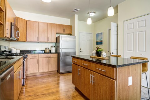 a kitchen with wooden cabinets and stainless steel appliances
