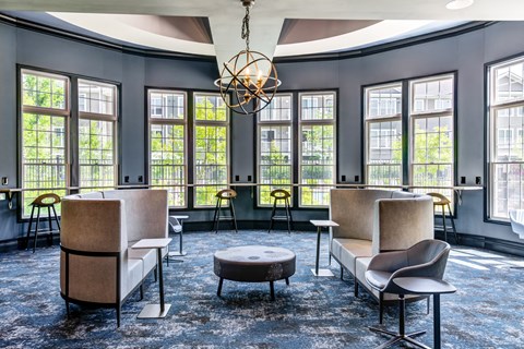 the community clubroom filled with modern furniture and a large windows