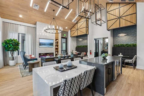 A modern kitchen with a dining table and chairs.