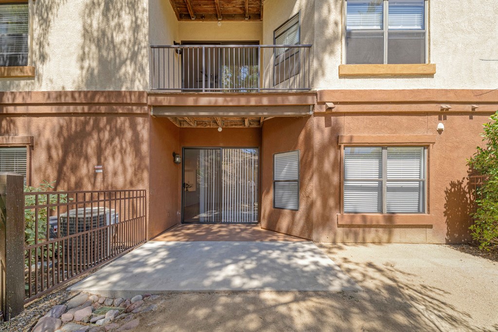 A building with a balcony and a gate.