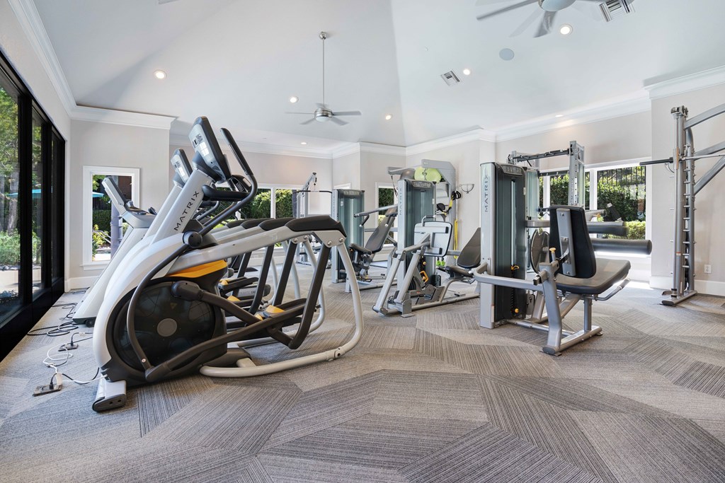 A spacious home gym with a variety of equipment.