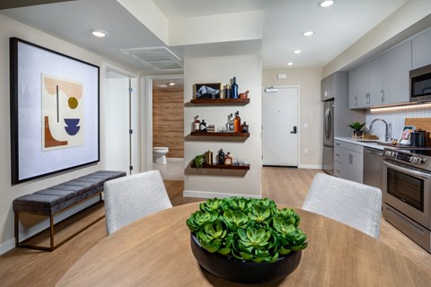 a kitchen and dining room with a table and chairs