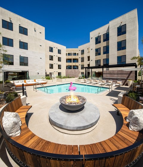 a swimming pool with a fountain in front of a building