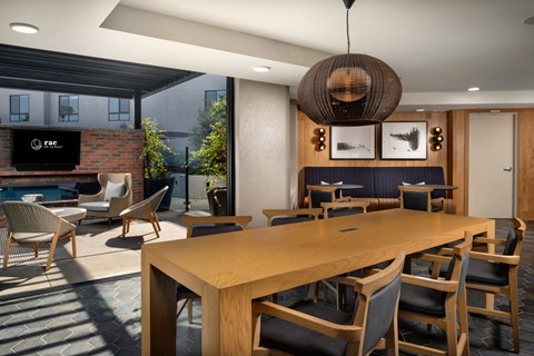 a dining room with a wooden table and chairs and a fireplace