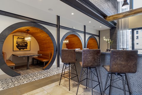 A modern dining area with a wooden table and chairs.