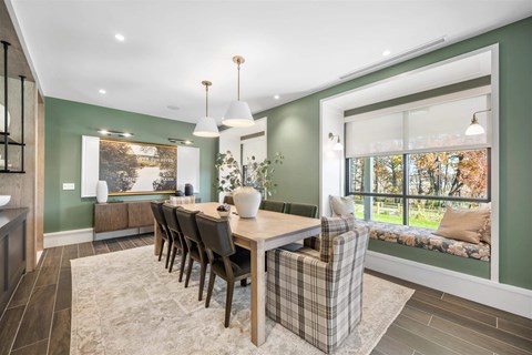 a dining room with a table and chairs and a window