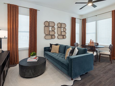 A living room with a blue couch and a coffee table.