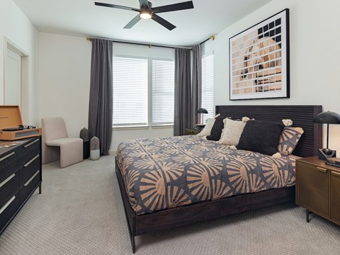spacious bedroom with carpet and king size bed