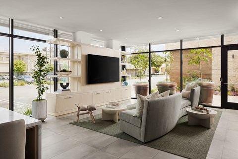 A modern living room with a large grey sofa and a flat screen TV.