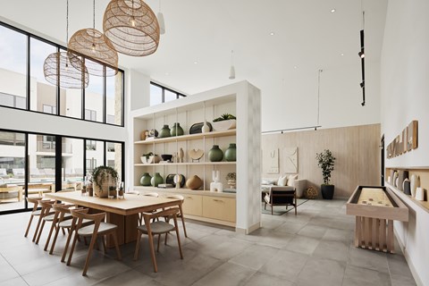 A modern dining room with a pool table and a long table with chairs.