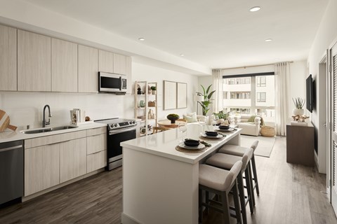 A modern kitchen with a dining table set for two.