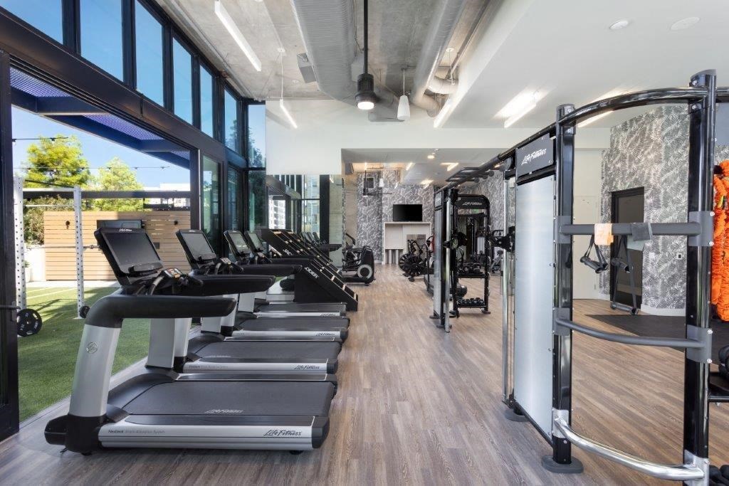 A gym with treadmills and other exercise equipment.