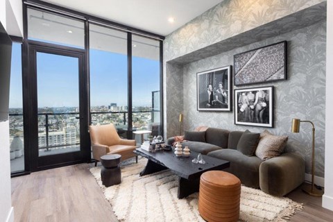 A modern living room with a view of the city through large windows.