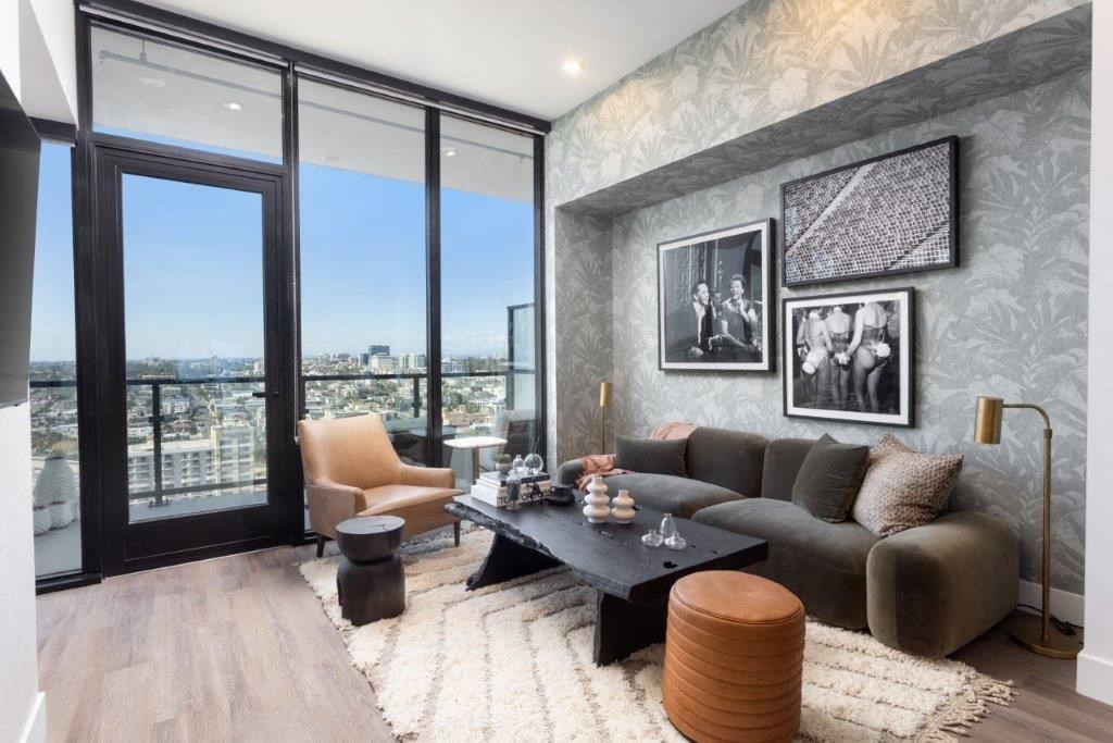 A modern living room with a view of the city through large windows.