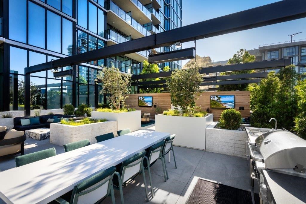 A modern outdoor seating area with tables and chairs.